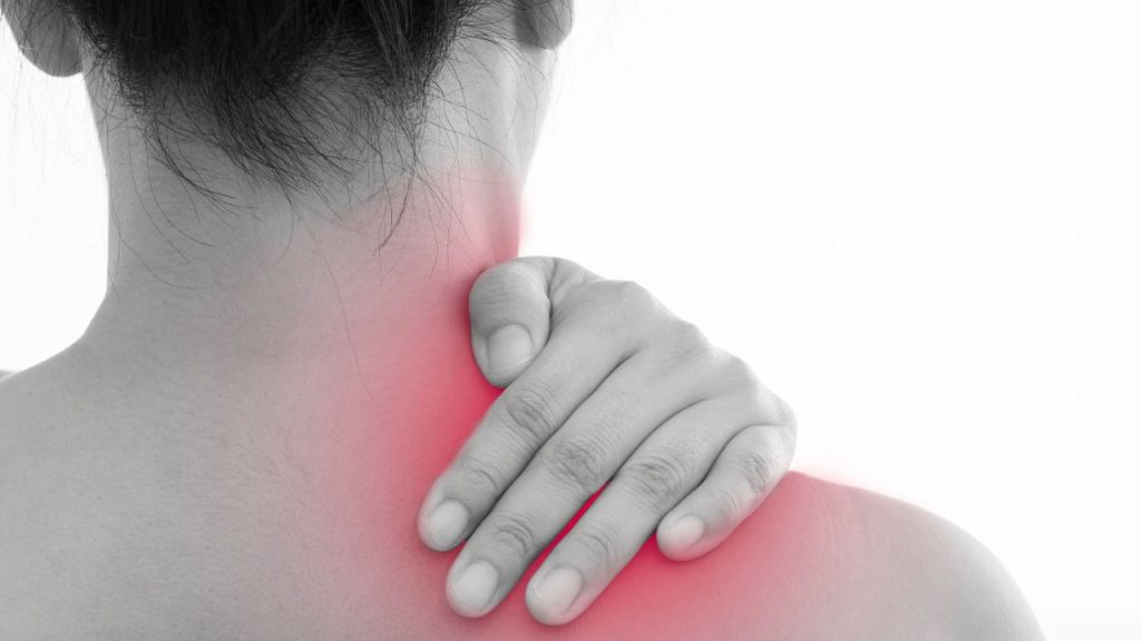 Sports woman massaging shoulder pain isolated on white background
